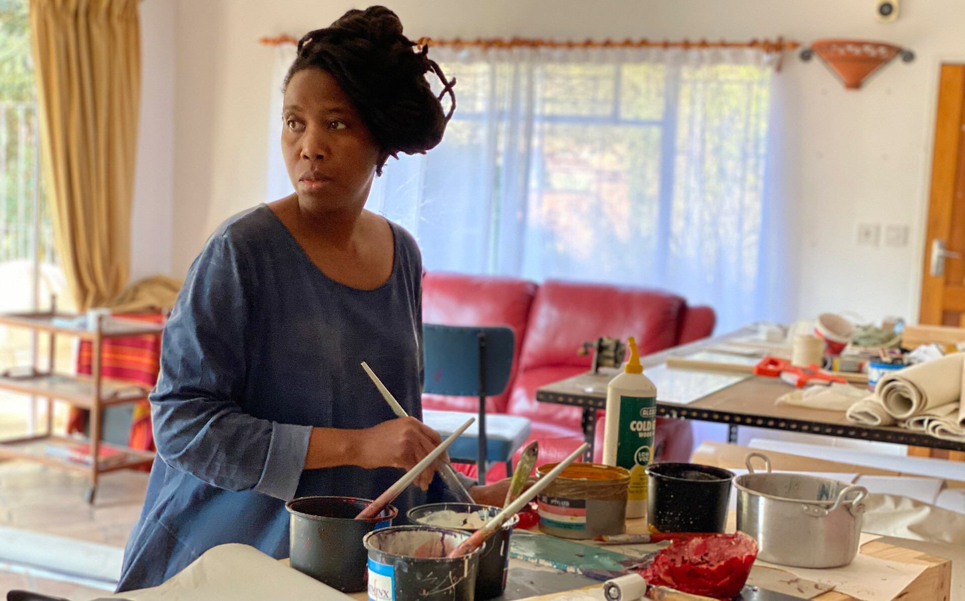 A photo of Portia Zvavahera working in her studio in Zimbabwe, in 2020.