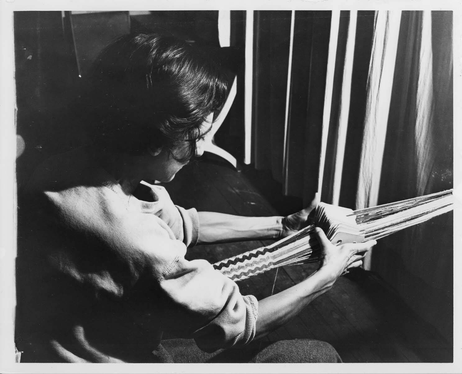 A photo of Anni Albers card weaving at Black Mountain College.